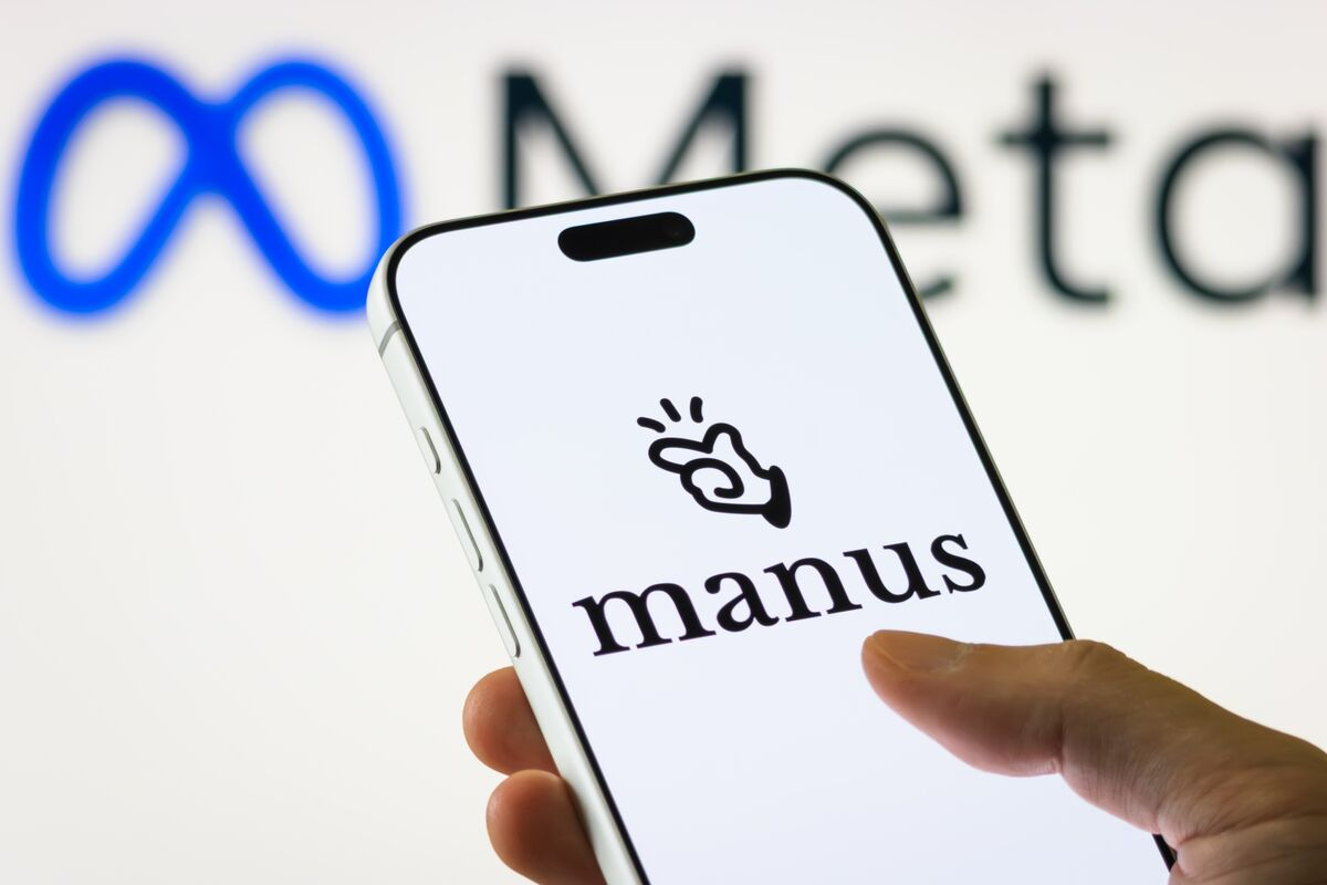 Smartphone displaying Manus logo with blurred Meta logo in the background.
